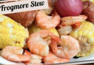 A close up of shrimp, corn on the cob and potatoes with text above them.