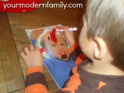 Kids drawing on pictures of themselves. 