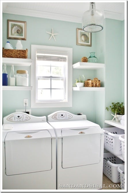 An organized laundry room with shelving above the washer and dryer.