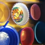 A close up of organized plastic bowls in a drawer.