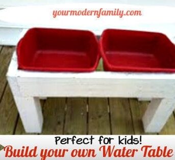 A wooden water table with two red plastic containers in it with text below it.