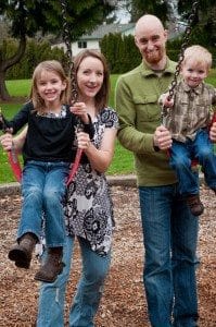 Fit to be family A group of people posing for the camera at a playground.