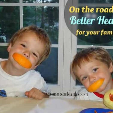 Two little boys sitting at the table with orange peels in their mouths with text above them.