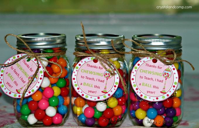 Glass mason jars with gumballs in it with a gift tag on each one.