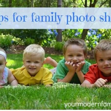Small children is lying in the grass posing for a picture with text above them.