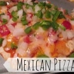 A Mexican pizza sitting  on a plate.