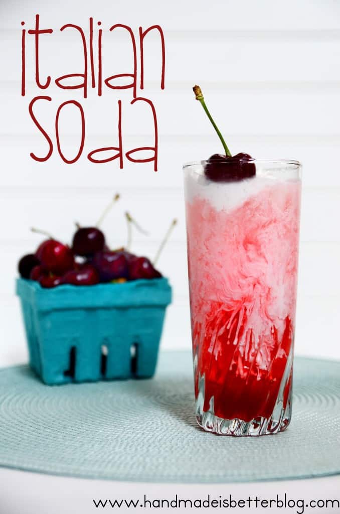 A glass of Italian soda with a container of cherries beside it.