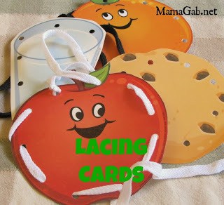 A craft made paper images of food with shoe laces fed through the holes in them.