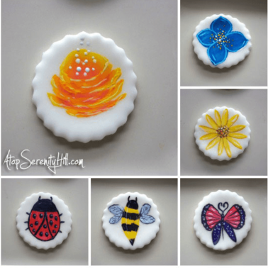 A close up of variety of cupcake toppers with different designs on them.