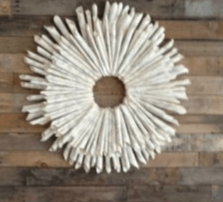 A DIY paper wreath on a wooden table.