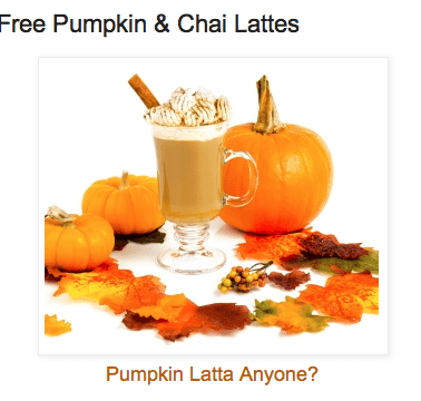 A glass containing a pumpkin latte with leaves and pumpkins around it.