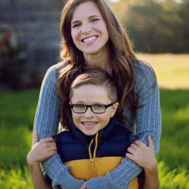 A woman and a little boy posing for the camera.