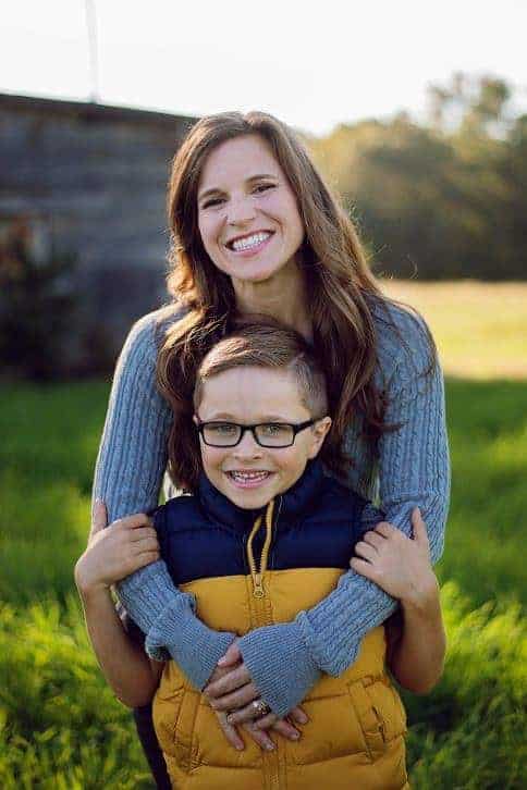 A woman and a little boy posing for the camera.