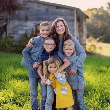 A woman and children posing for a picture.