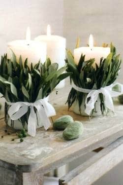 Christmas candles decorated with foliage and bows.