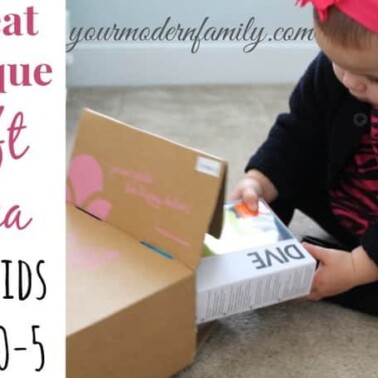 A little girl that is pulling a gift out of a box with text beside her.
