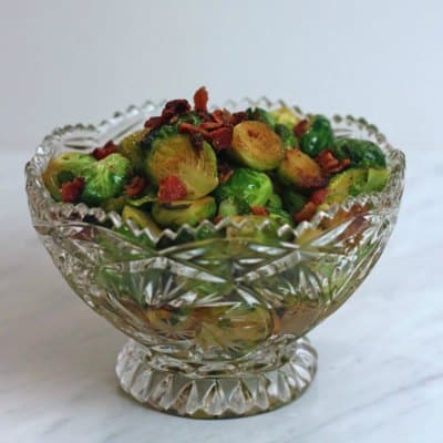 A bowl of Brussels sprouts on a table.
