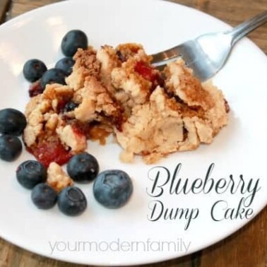 A plate of Blueberry Dump Cake on a white plate with a fork resting on the plate.