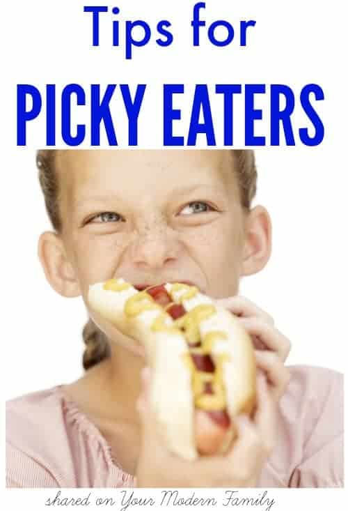 A girl eating a hot dog with text above her.