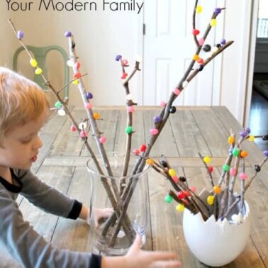 A boy making an Easter Tree with jelly beans.