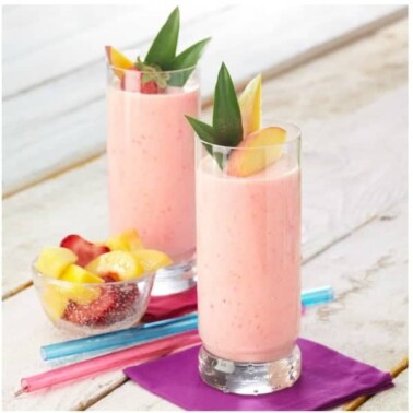 Two glasses of smoothies on a table.