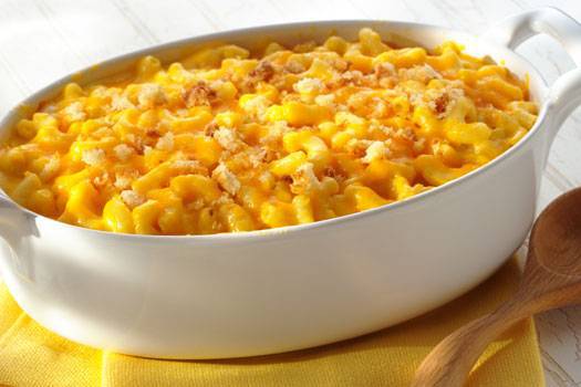 A bowl of Mac n Cheese in a white casserole dish.