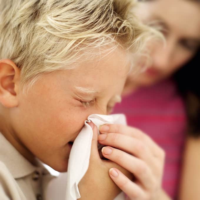 Boy Blowing His Nose into a Handkerchief