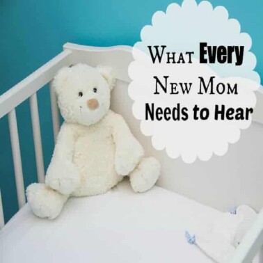A white bear sitting in a white crib with text beside it.