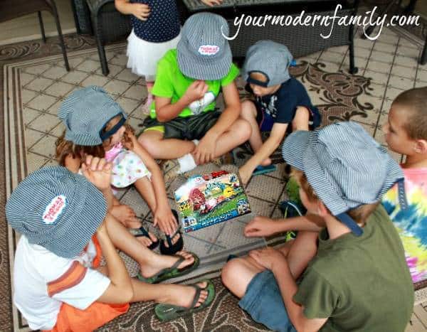 A group of kids playing a game on the floor.