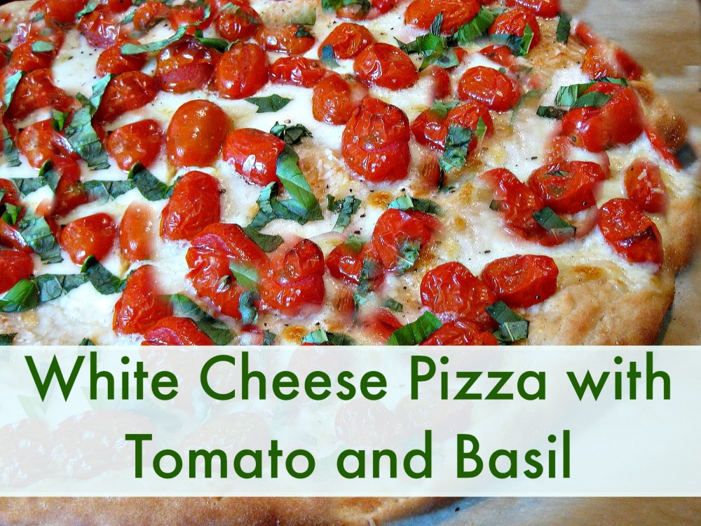 white cheese pizza with tomato and basil