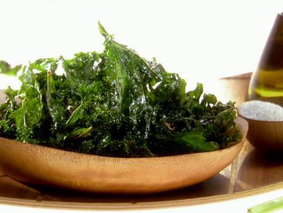 A bowl of leafy greens in a wooden bowl.