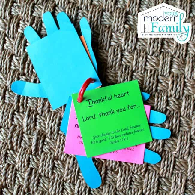 Paper hands cut out with prayers written on them.