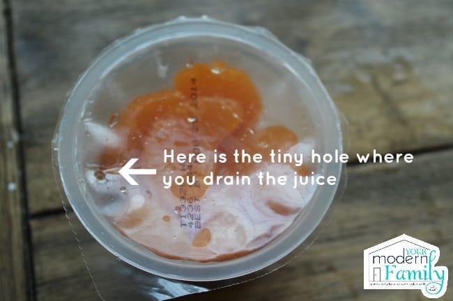 A container of fruit with directions on how to drain the juice.