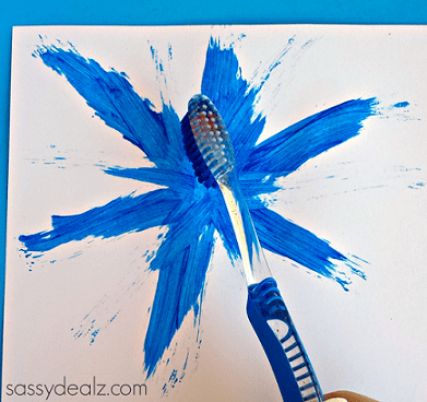 A toothbrush being used as a paintbrush.