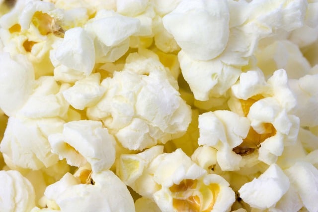 A close up of a bowl of ice cream, with Popcorn