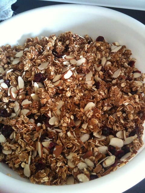 A bowl of cut oats and nuts.