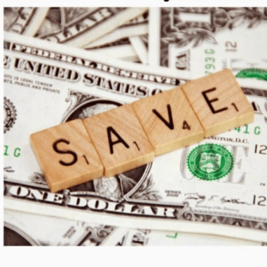A close up of dollar bills on a table with Scrabble tiles spelling out the word SAVE on top of them.