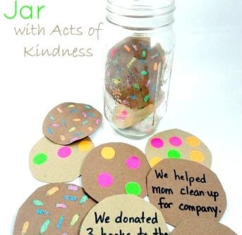 Child's craft of paper cookies with text on them and a glass jar.