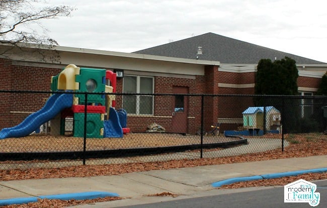 A playground outside of a school building.