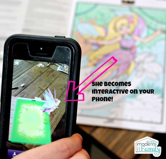 A cellphone showing how to use an interactive crayon app.