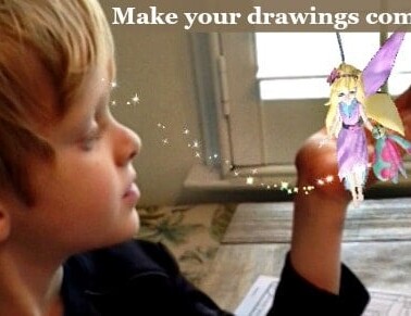 A child looking at his completed craft with sparkles floating toward him.