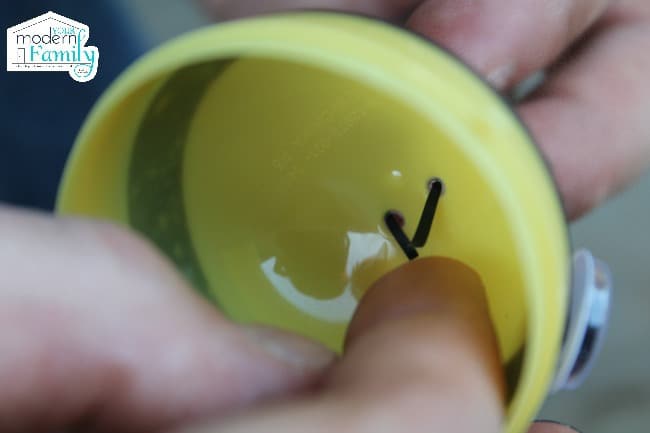 securing hair tape strips on the inside of a plastic easter egg