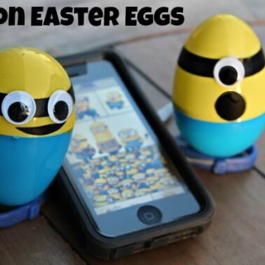 Two minion Easter eggs with a cell phone sitting between them.