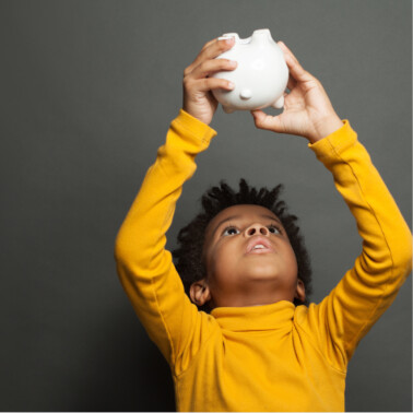 boy looking in piggy bank