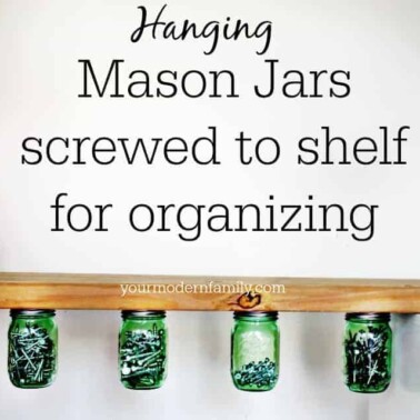 Mason jars hanging from a wooden shelf with text above it.