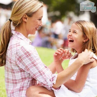 A woman and a young girl laughing together.