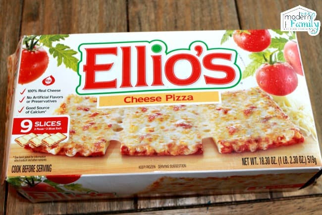 A box of Elliio\'s Pizza sitting on a wooden table.
