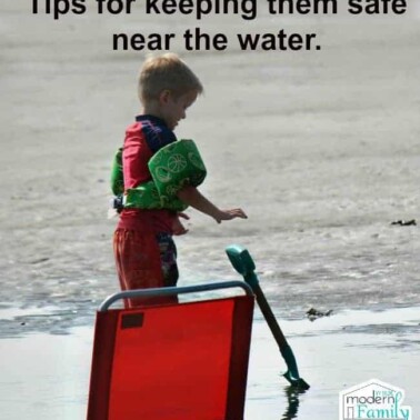A little boy that is standing near the water wearing a puddle jumper for safety with text above him.