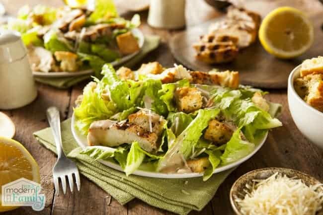 A plate of Caesar Salad on a table.