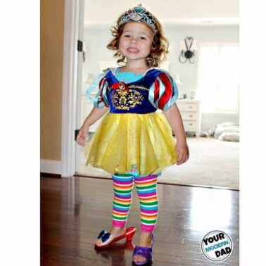 A little girl dressed up at a Disney Princess with high heels.